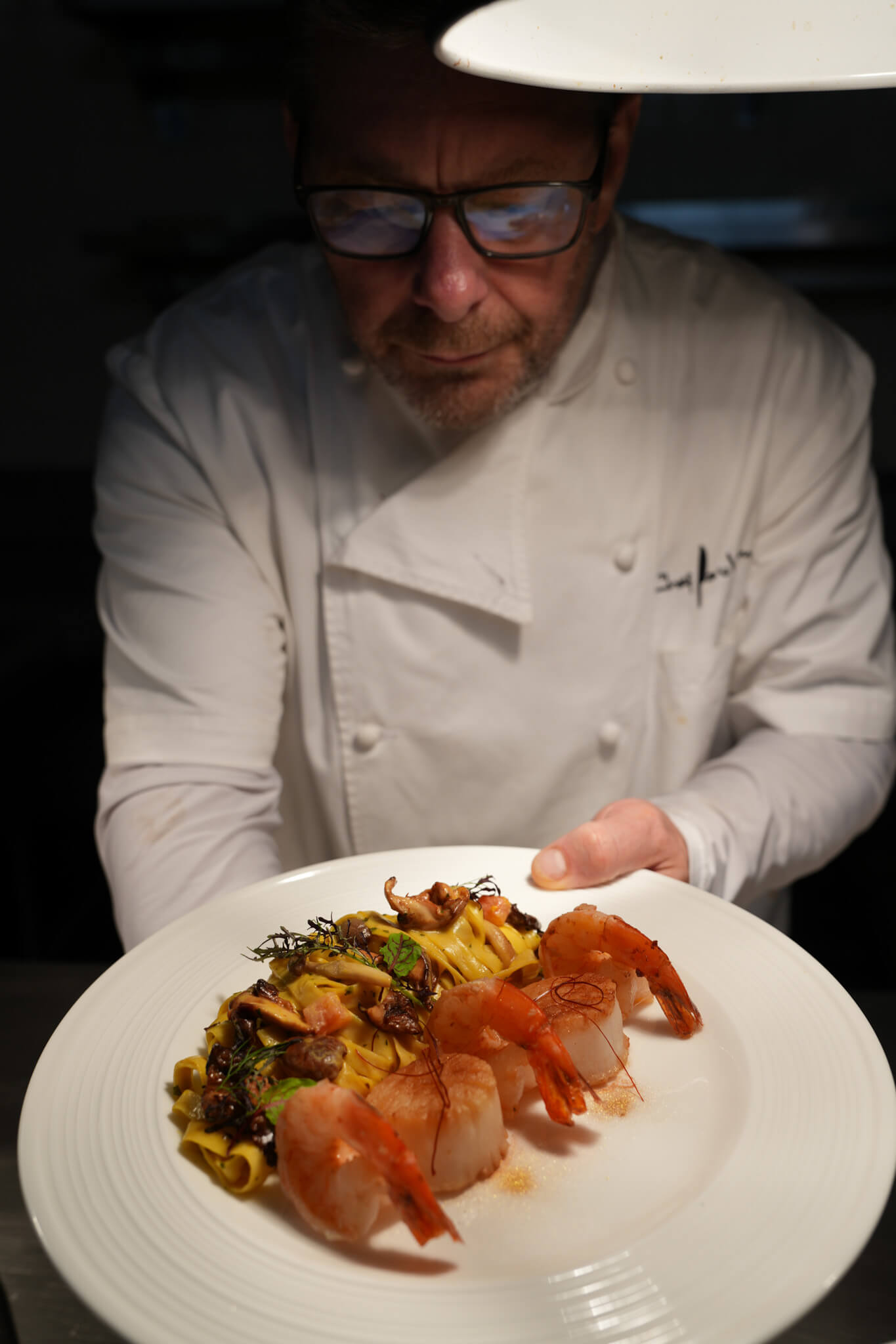 Professional chef's jacket with Chef Paul Syms branding